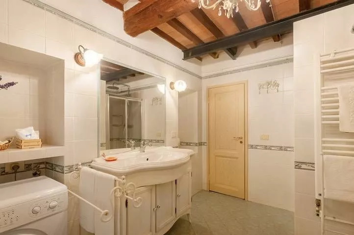 Bright bathroom with shower and double sink at Podere Settefrati apartment