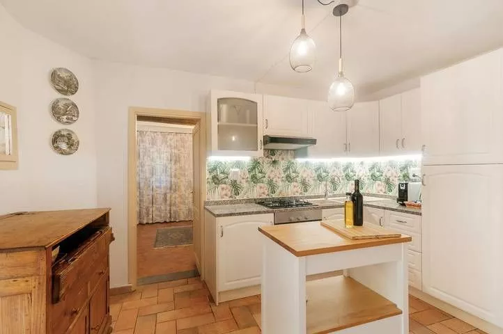 Country-style kitchen with island and bright decor at Podere Settefrati Tuscany