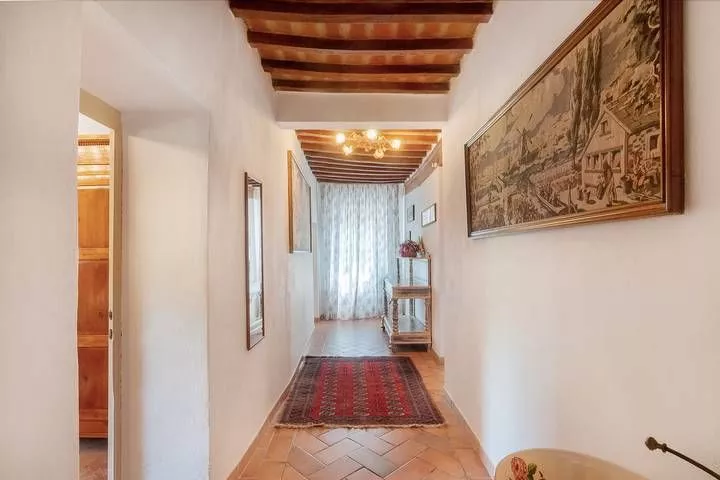 Bright hallway with terracotta floor and artwork at Podere Settefrati apartment