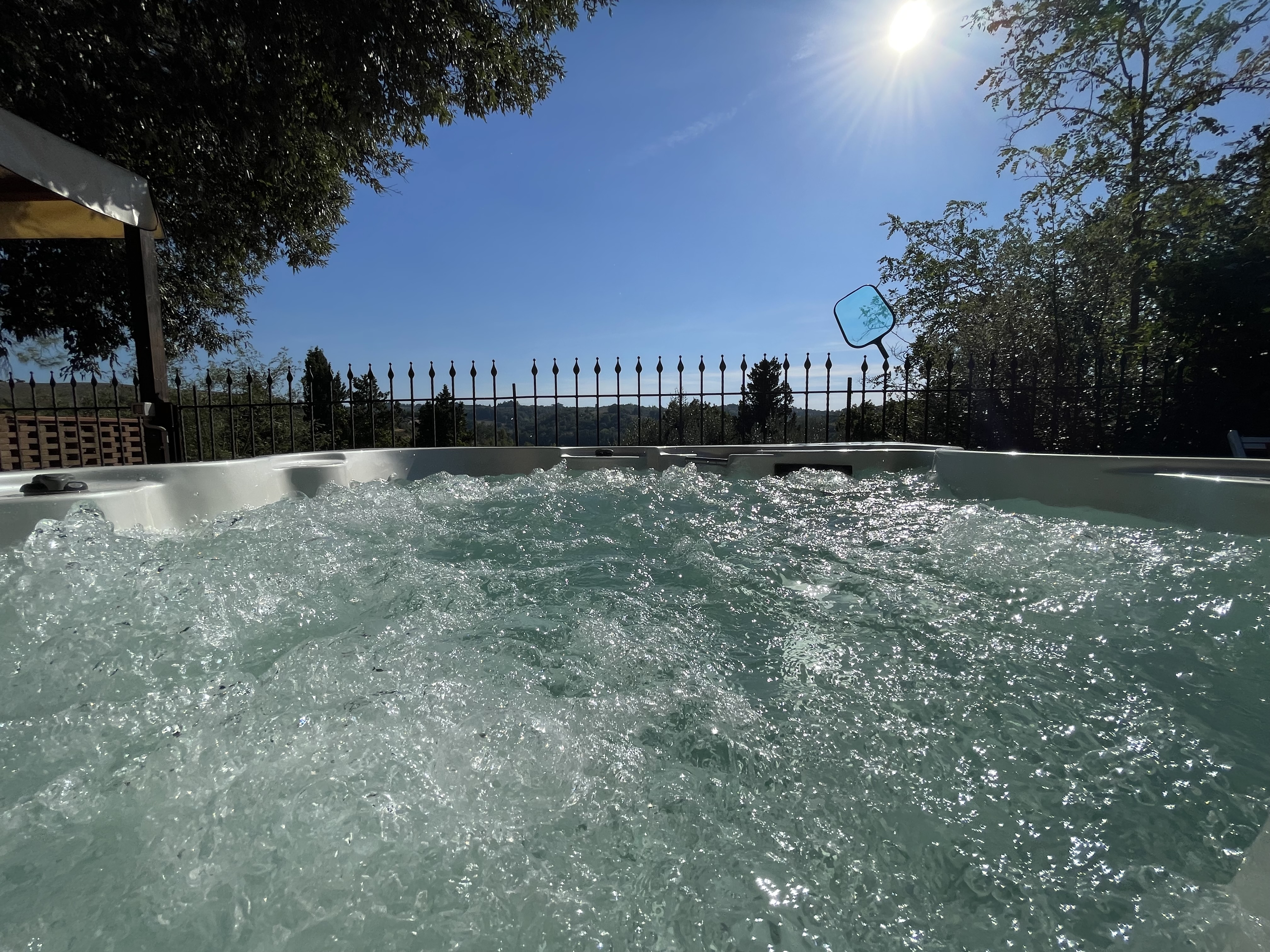 Outdoor jacuzzi pool with countryside view at Podere Settefrati farmhouse in Tuscany