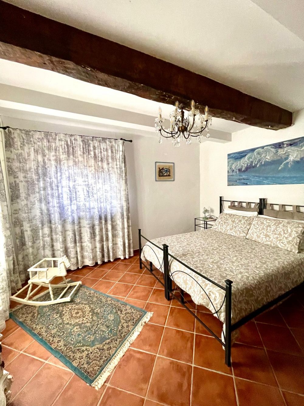 Bedroom with large window and view of Tuscan hills