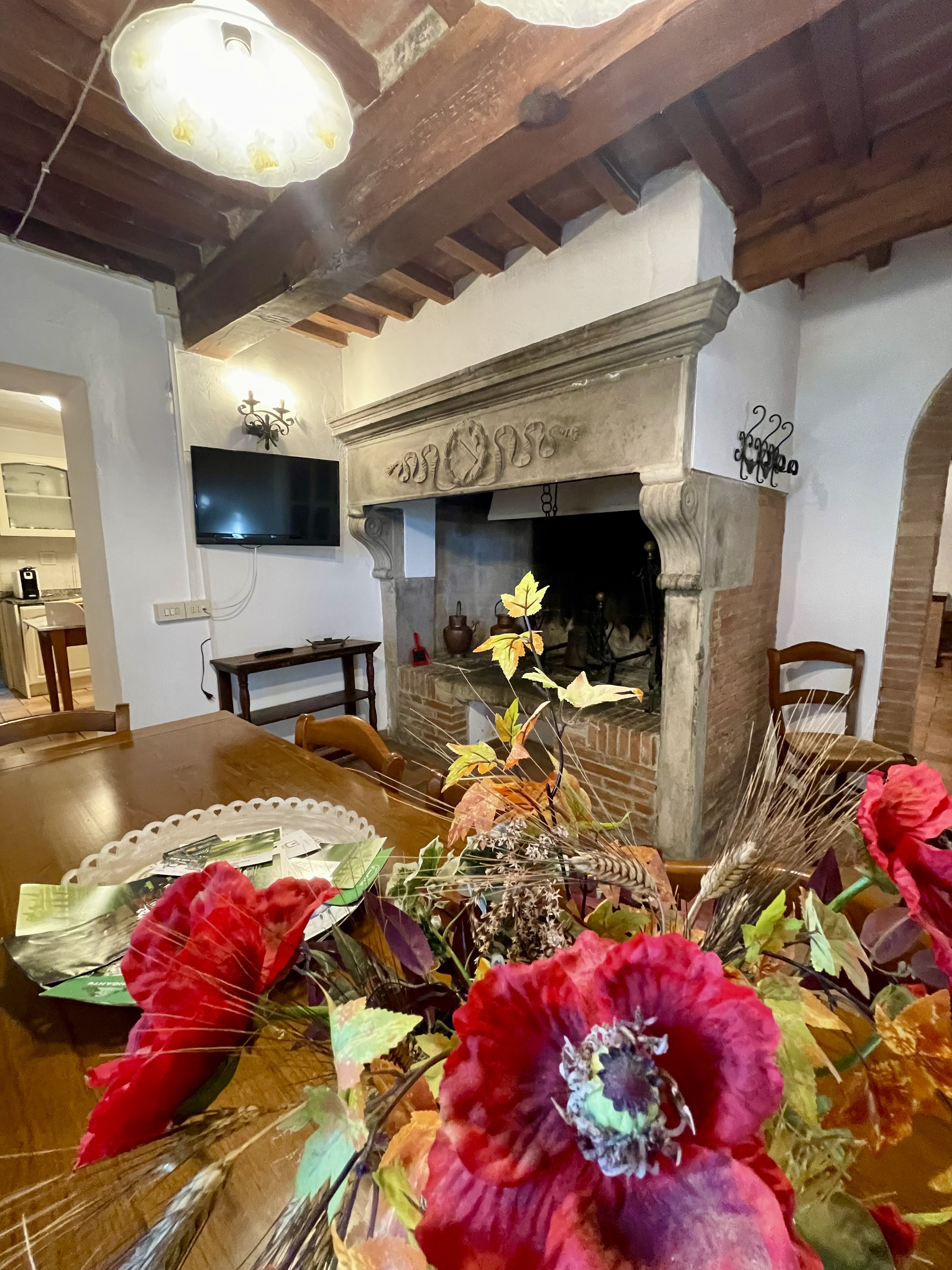 Fireplace in the farmhouse living room at Podere Settefrati