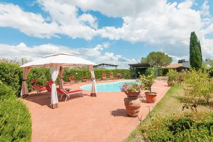 Pool terrace with sun umbrellas and panoramic view at Podere Settefrati Tuscany