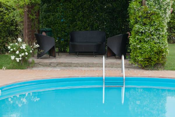 Sunbeds and umbrellas by the outdoor pool at Podere Settefrati farmhouse in Tuscany